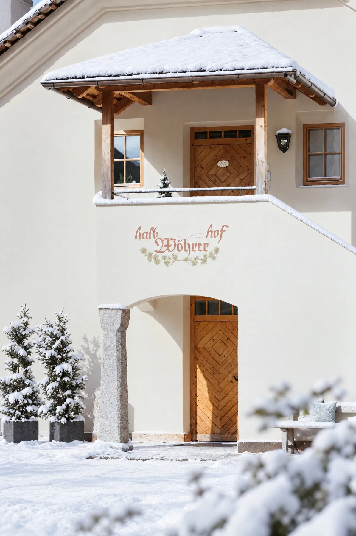 Der Eingang mit der gemalten Hofschrift im Schnee