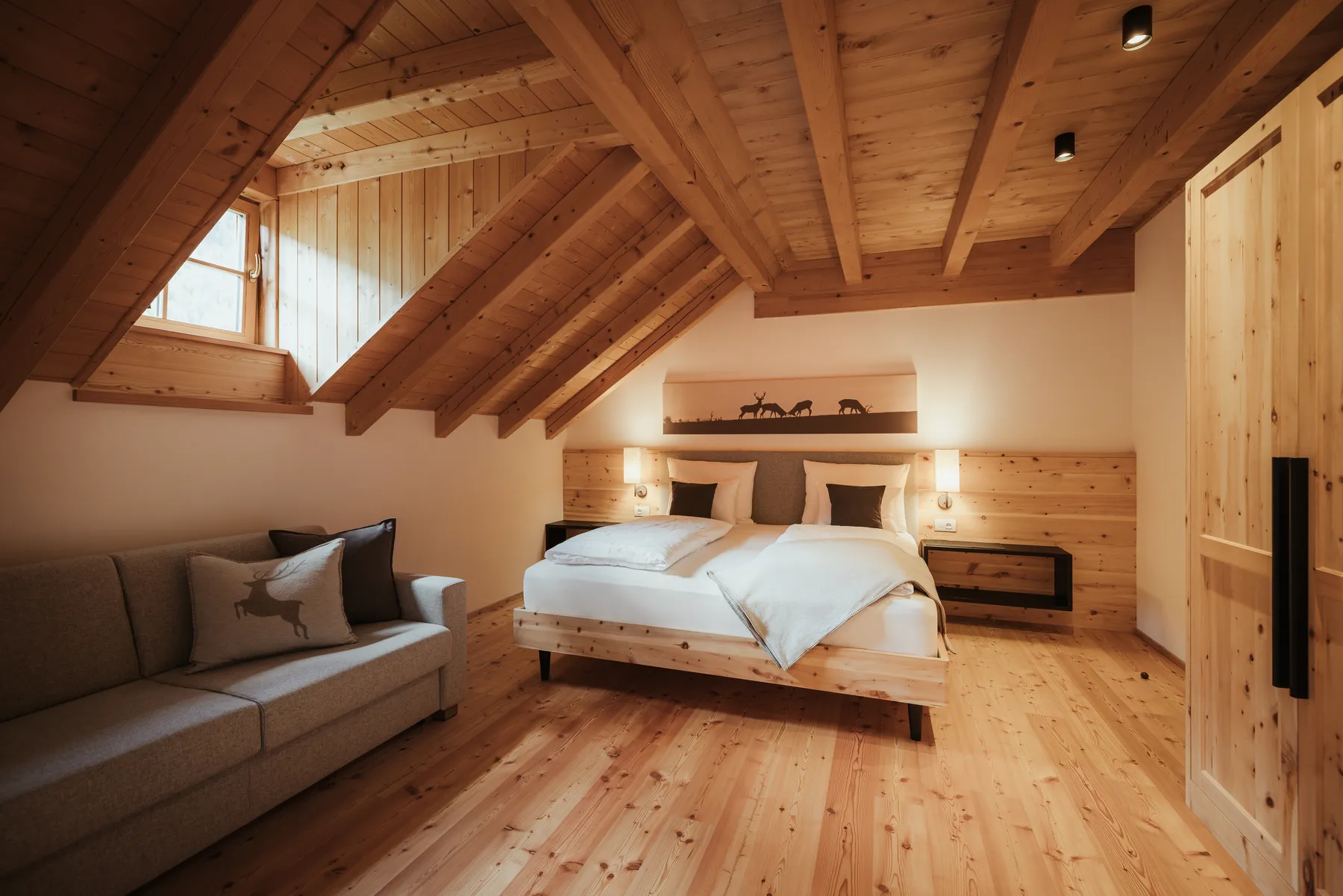 Schlafzimmer mit Sofa und Blick ins Bad